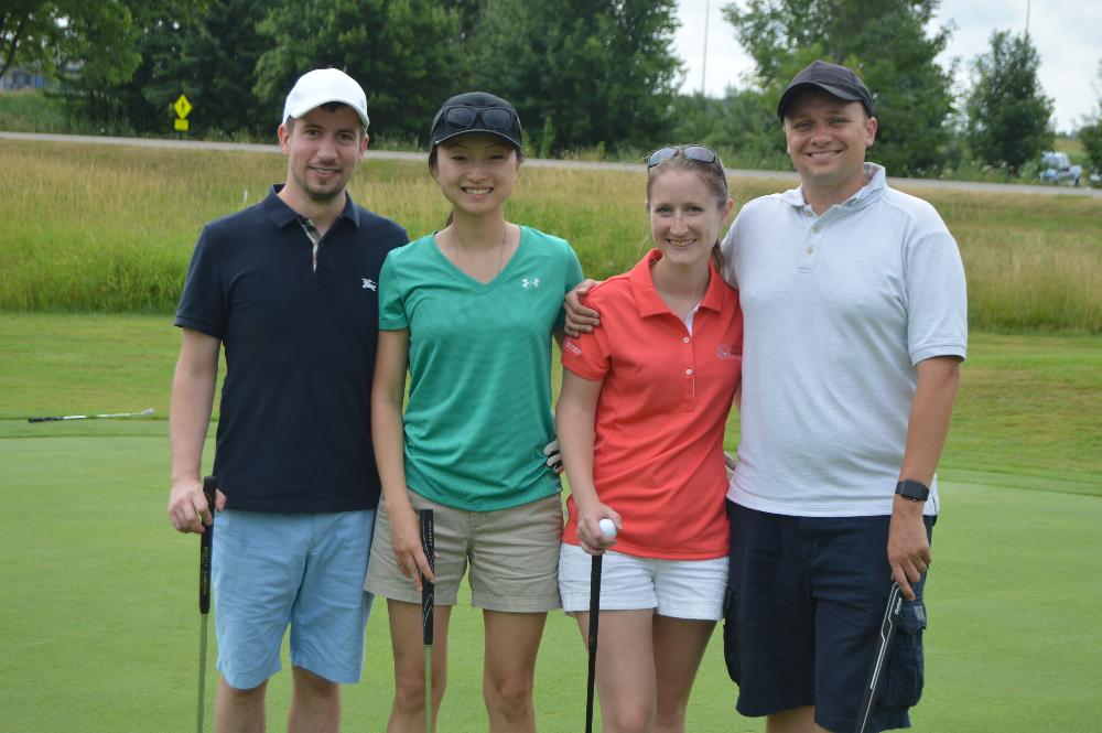 A golf team of 4 alumni.